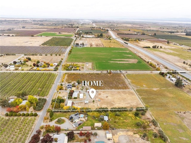 birds eye view of property with a rural view