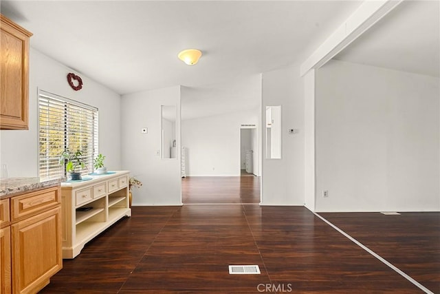 hall featuring vaulted ceiling with beams and dark hardwood / wood-style floors