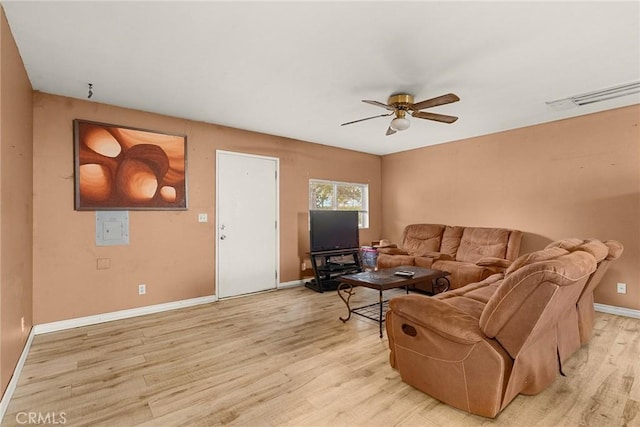 living room featuring ceiling fan and light hardwood / wood-style floors