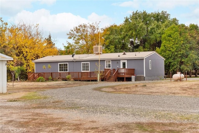 view of front of property featuring a deck and central air condition unit