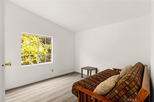 sitting room with vaulted ceiling and light hardwood / wood-style flooring