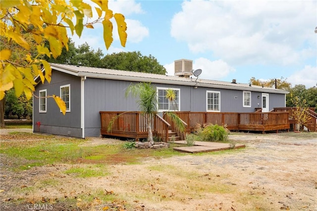 back of house with a deck