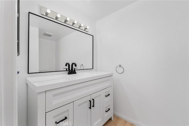 bathroom with hardwood / wood-style flooring and vanity