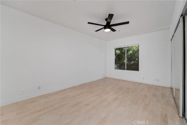 unfurnished room featuring ceiling fan and light hardwood / wood-style flooring