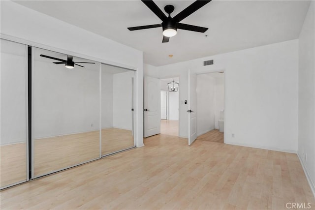 unfurnished bedroom featuring ceiling fan and light hardwood / wood-style flooring