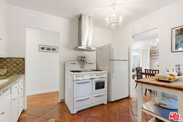 kitchen with white cabinetry, white appliances, crown molding, and wall chimney range hood