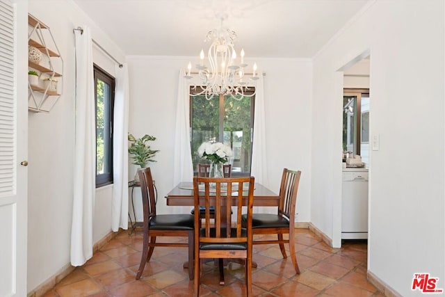 dining room featuring a chandelier, tile patterned flooring, and ornamental molding