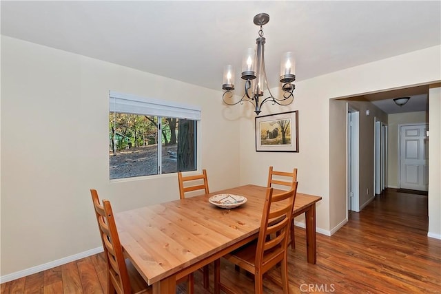 dining room featuring a notable chandelier and dark wood-type flooring