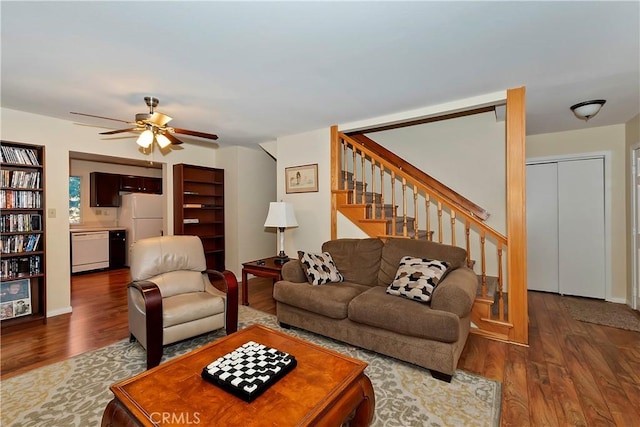 living room featuring ceiling fan and dark hardwood / wood-style flooring