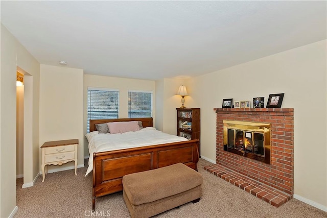 bedroom with carpet floors and a fireplace