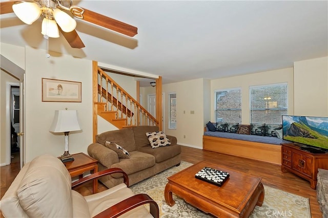 living room with light hardwood / wood-style floors and ceiling fan