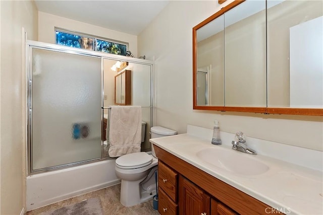 full bathroom featuring combined bath / shower with glass door, vanity, and toilet