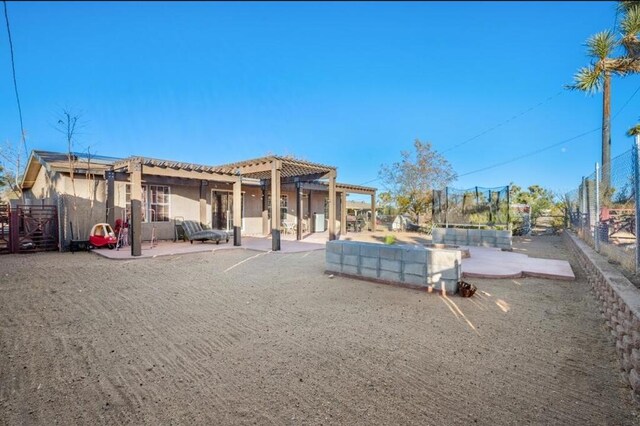 back of house featuring a swimming pool, a patio, and a pergola