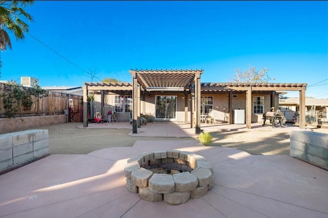 rear view of house featuring an outdoor fire pit, a pergola, and a patio