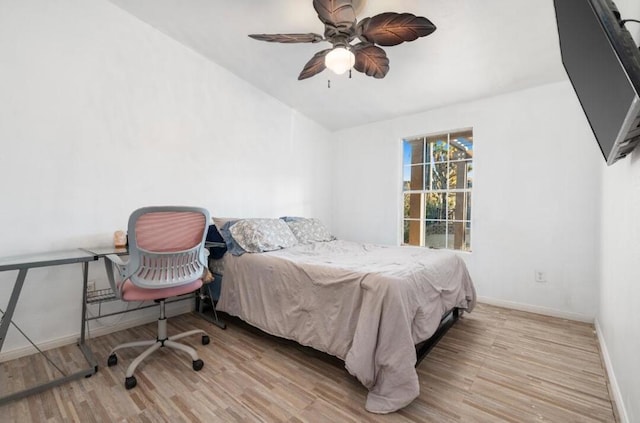 bedroom featuring ceiling fan, lofted ceiling, and light hardwood / wood-style floors