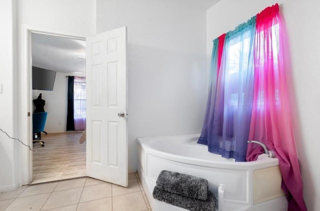 bathroom with tile patterned floors and a bathing tub