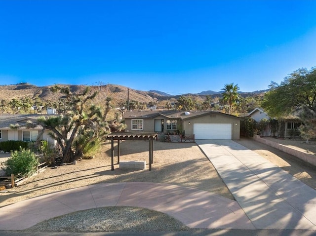 single story home featuring a mountain view and a garage