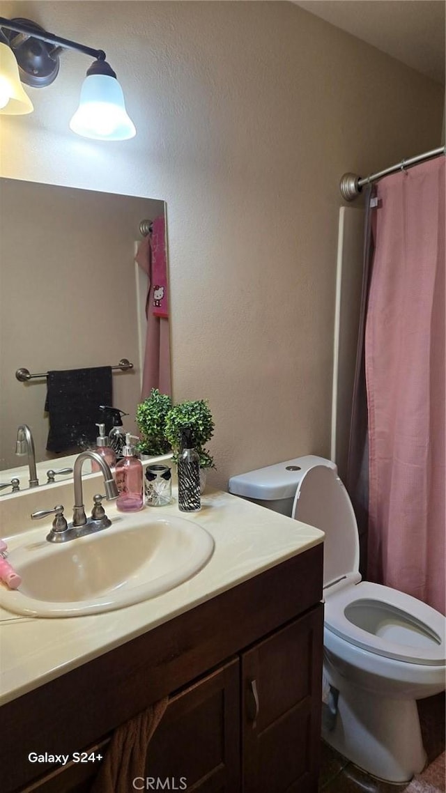 bathroom with vanity and toilet