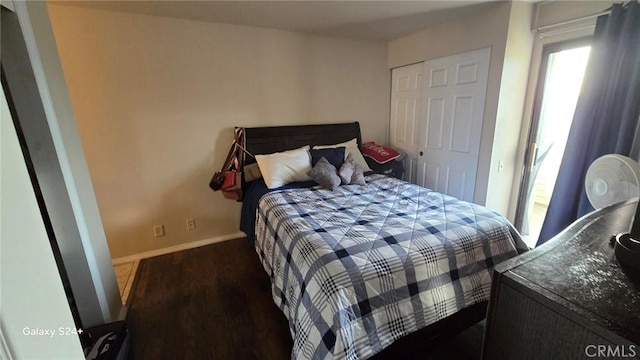 bedroom with a closet and dark hardwood / wood-style flooring