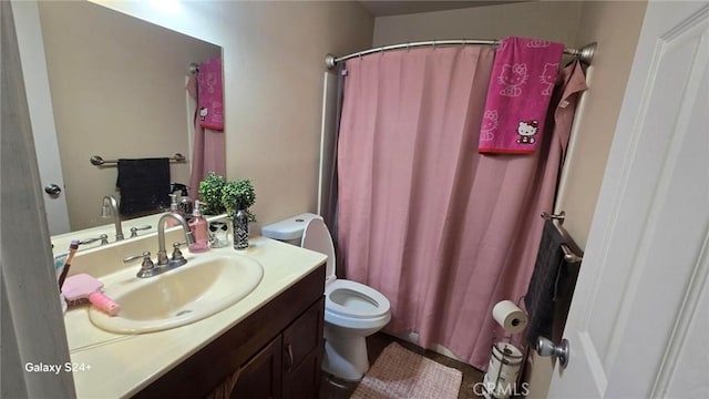 bathroom with vanity, a shower with shower curtain, and toilet