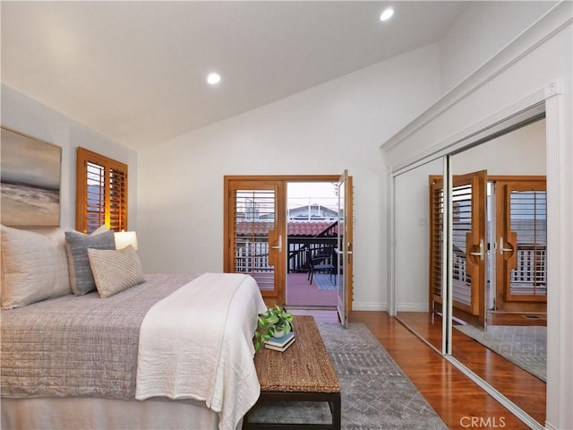 bedroom with lofted ceiling, wood finished floors, access to outside, a closet, and recessed lighting