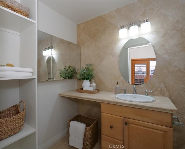 bathroom featuring decorative backsplash, tile walls, and vanity