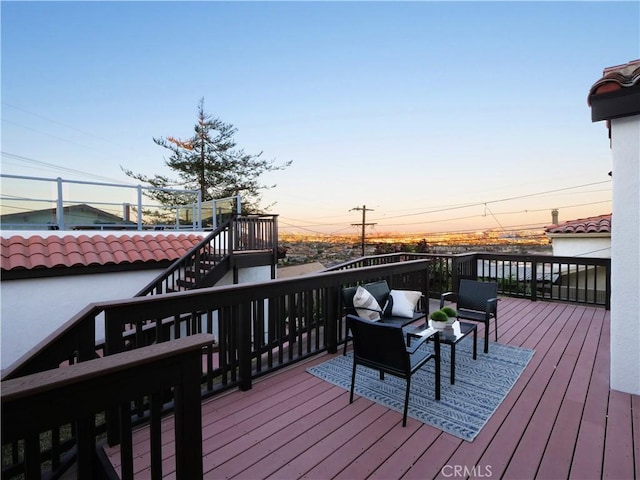 deck at dusk featuring stairway