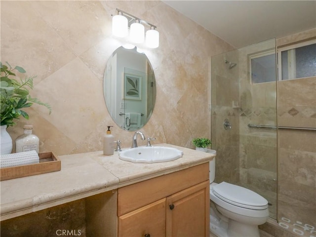 bathroom featuring tiled shower, vanity, and toilet