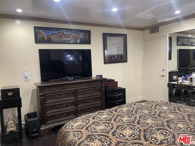 bedroom with ornamental molding and dark wood-type flooring