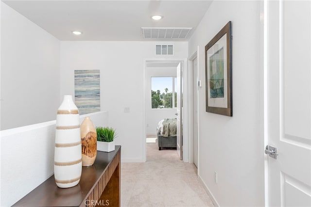 hall featuring light colored carpet