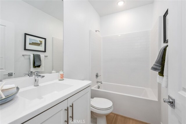 full bathroom featuring vanity, toilet, wood-type flooring, and shower / tub combination