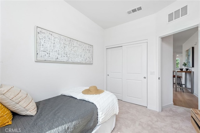 carpeted bedroom with a closet