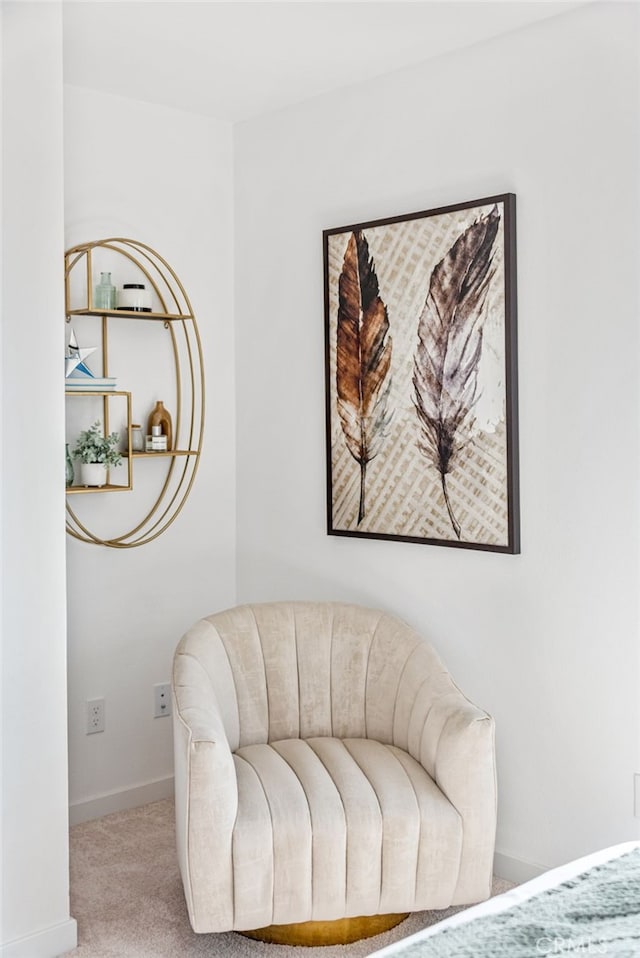 sitting room featuring light colored carpet