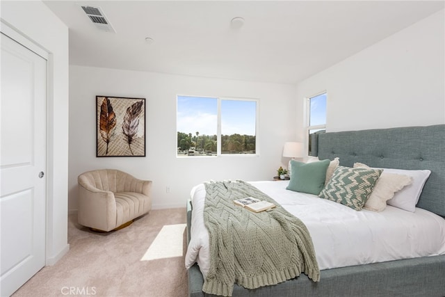 bedroom featuring light colored carpet