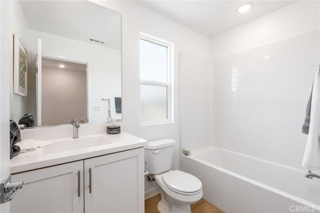 full bathroom with washtub / shower combination, vanity, and toilet