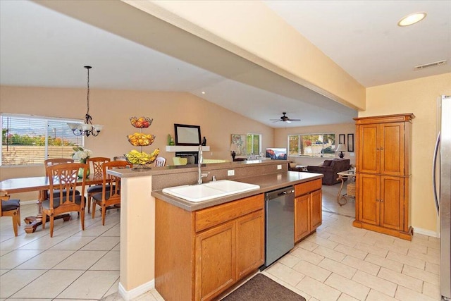 kitchen with sink, hanging light fixtures, a center island with sink, ceiling fan with notable chandelier, and appliances with stainless steel finishes