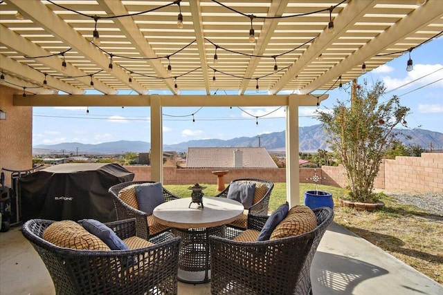 view of patio with a mountain view, a pergola, and grilling area