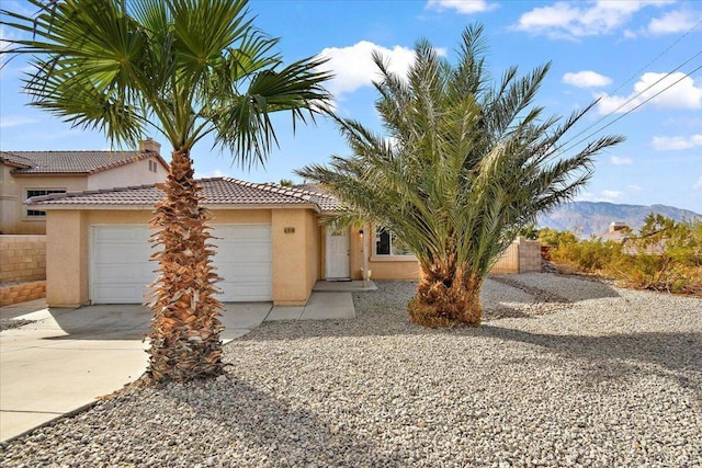 view of front facade featuring a mountain view and a garage