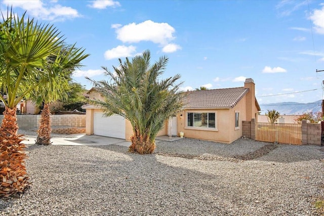 view of front of property featuring a mountain view and a garage