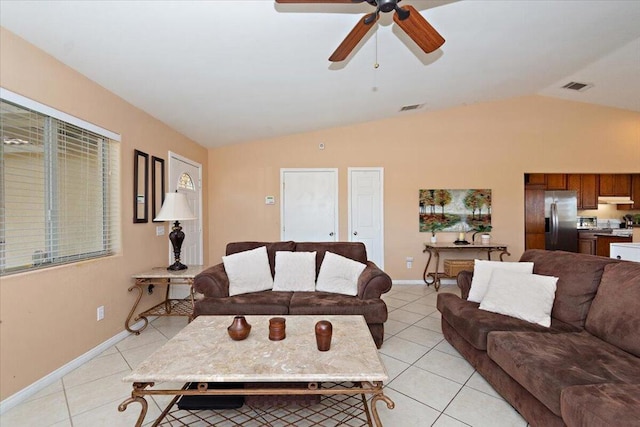 tiled living room featuring ceiling fan and lofted ceiling