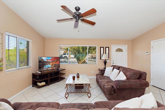 living room featuring ceiling fan, light tile patterned floors, and lofted ceiling