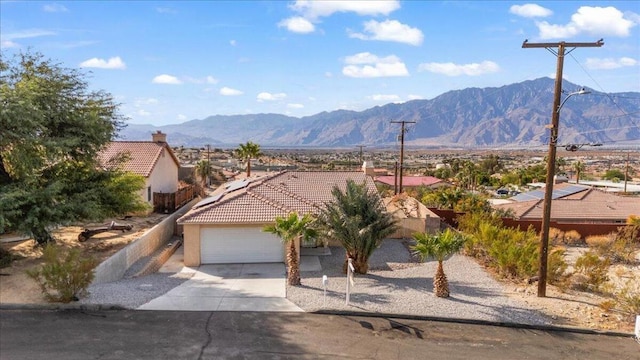 view of front of home featuring a mountain view and a garage