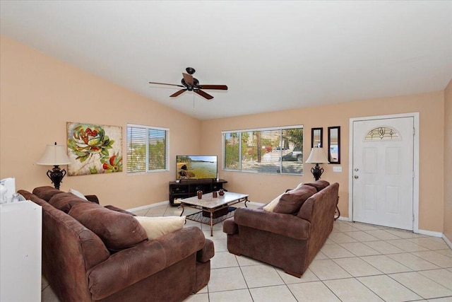 living room featuring ceiling fan, lofted ceiling, and light tile patterned flooring