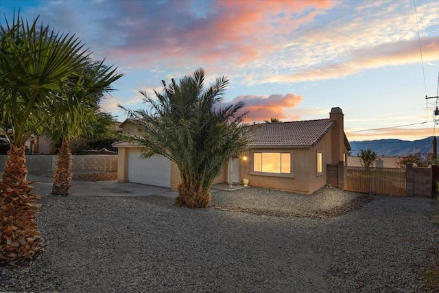 view of front of property featuring a mountain view and a garage