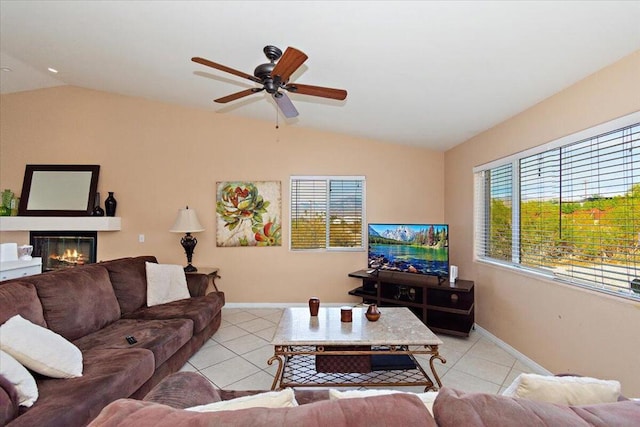 living room with ceiling fan, lofted ceiling, and light tile patterned flooring