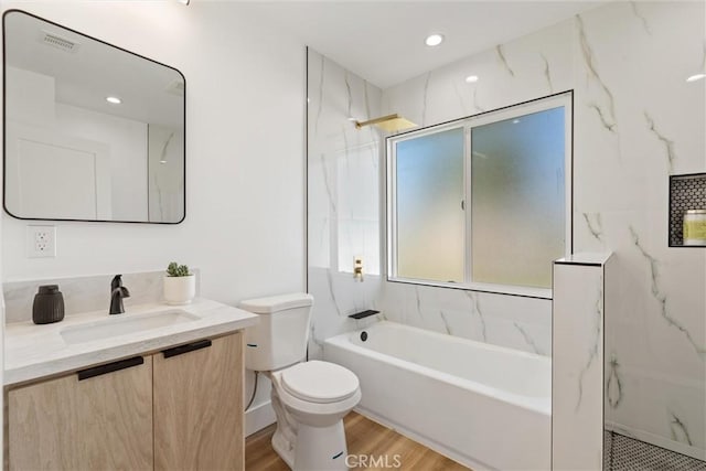 full bathroom featuring vanity, wood-type flooring, shower with separate bathtub, and toilet