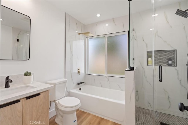 full bathroom with vanity, toilet, wood-type flooring, and independent shower and bath