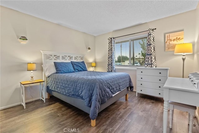 bedroom with dark hardwood / wood-style flooring and a textured ceiling