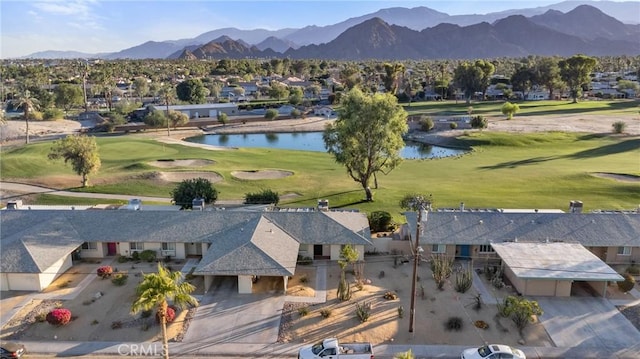 birds eye view of property with a water and mountain view