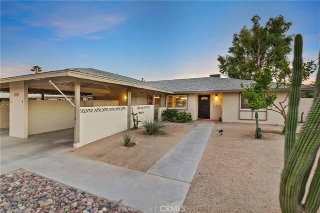 single story home featuring a carport